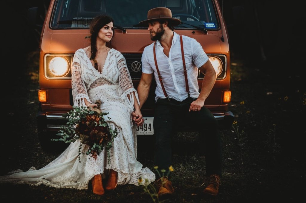 newlyweds leaning on a van