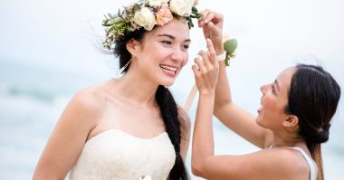 woman fixing flower crown of the bride