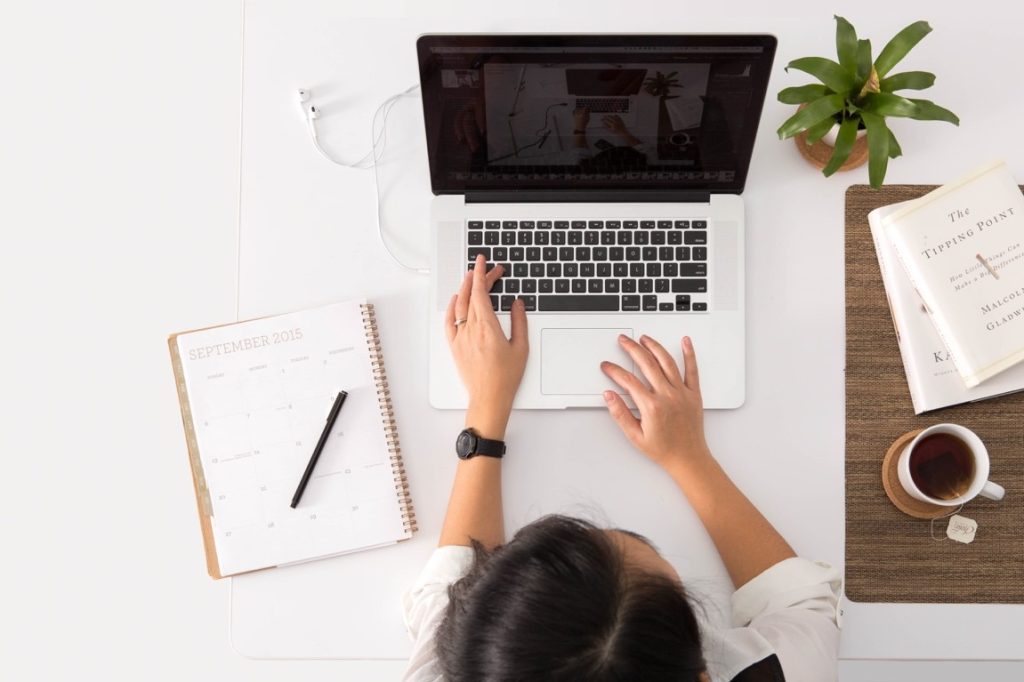 woman typing on a laptop