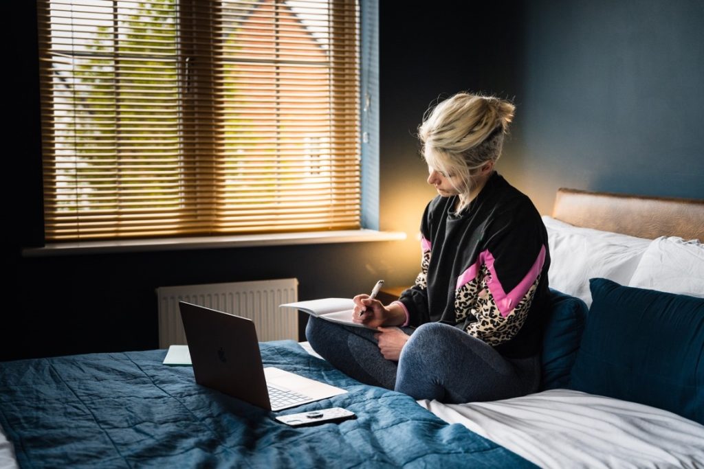 woman writing in bed