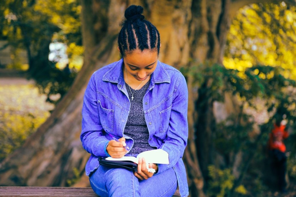 woman writing on her diary