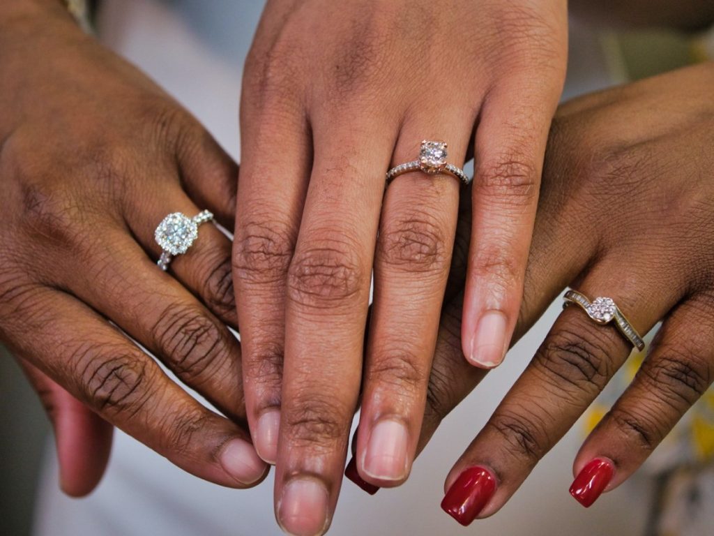 women showing off their rings