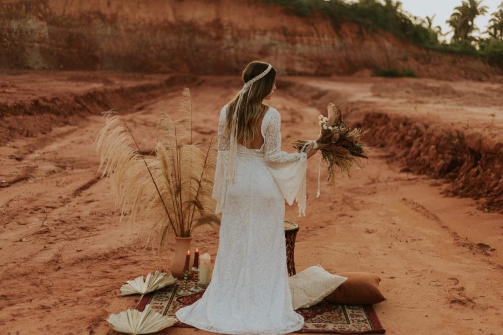 back of bride holding wildflowers