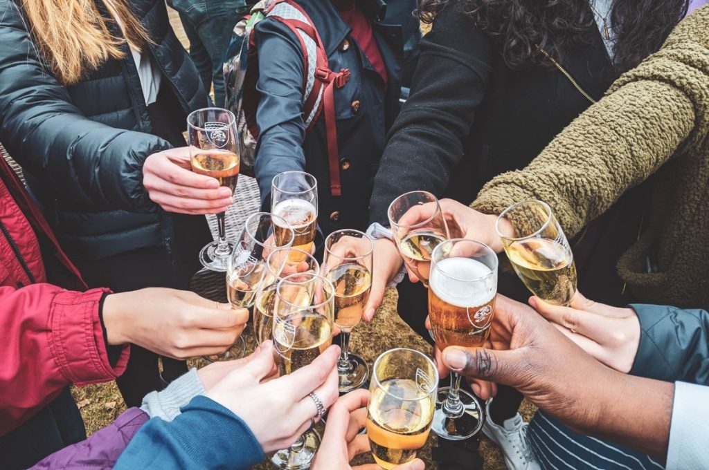 group of people clinking wine glasses