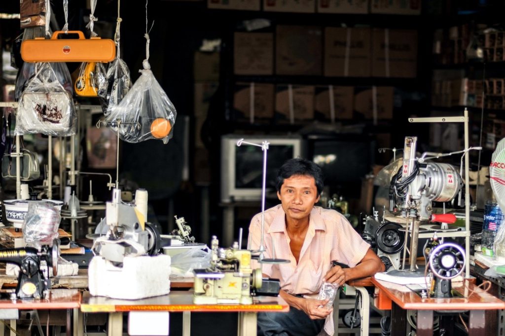 portrait of a male seamstress in his shop