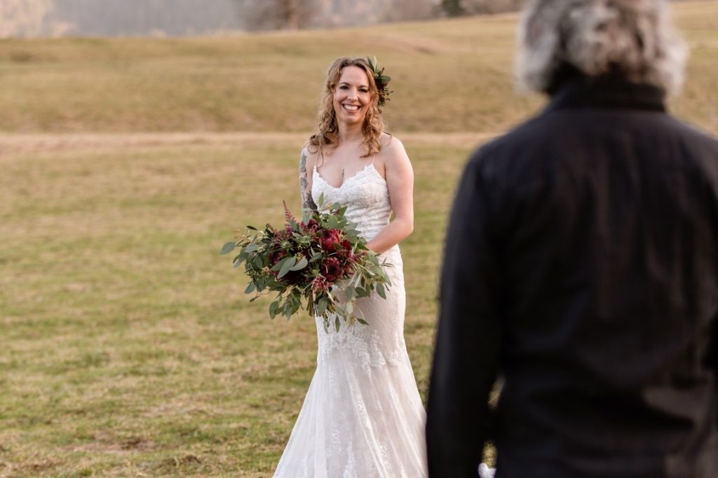 smiling bride looking at father