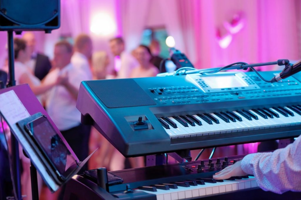 man playing piano at a wedding