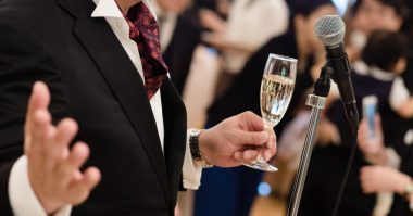 man wearing a suit giving a speech