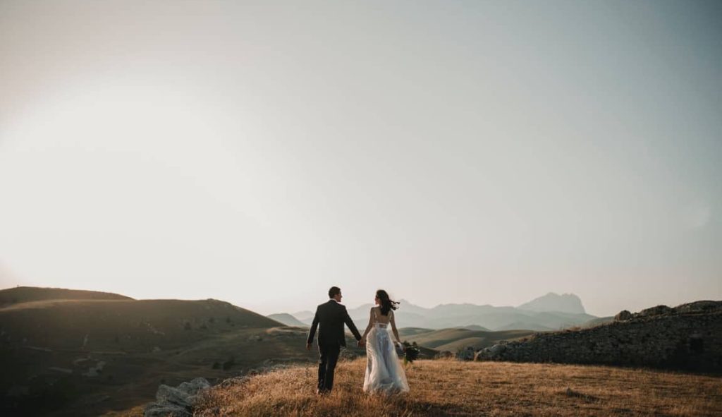 portrait of newlyweds on a hill