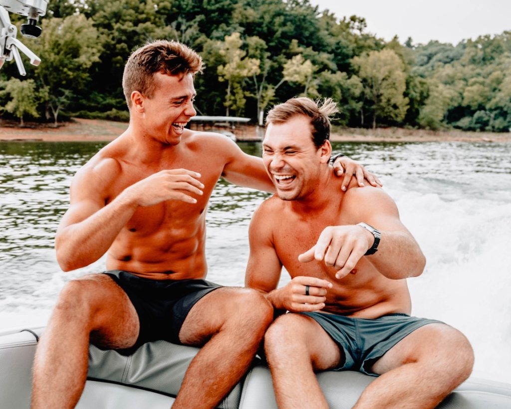 two men laughing on a boat