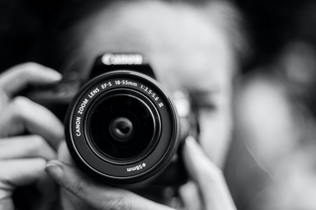 woman taking a picture using a dslr camera