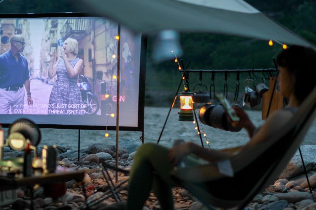 woman watching movie on projector