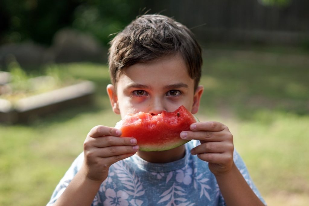 boy holding a watermelon