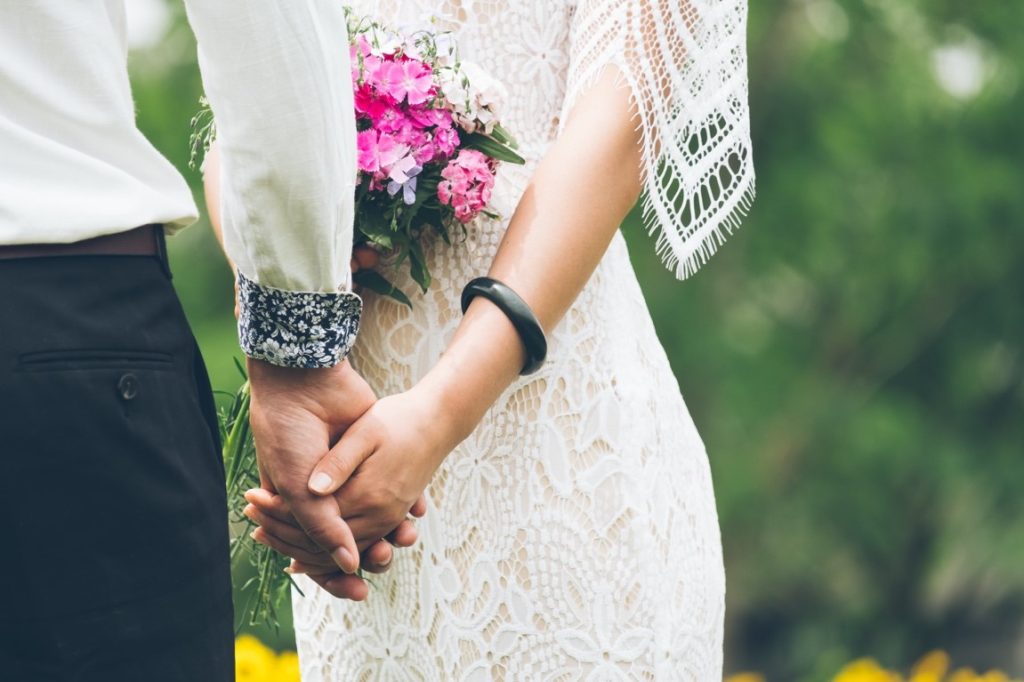 bride and groom holding hands