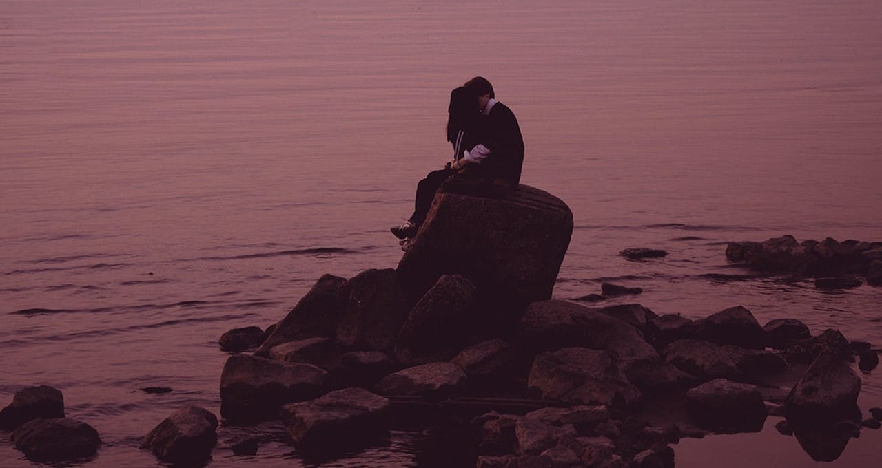 couple sitting on a rock