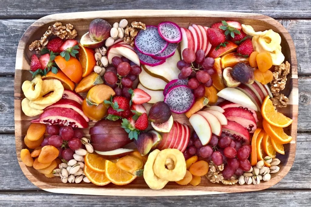 cut out fruits on a wooden service plate