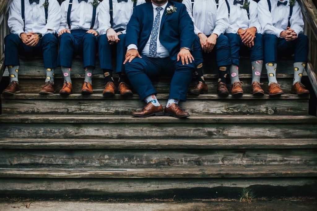 groom and groomsmen sitting on stairs