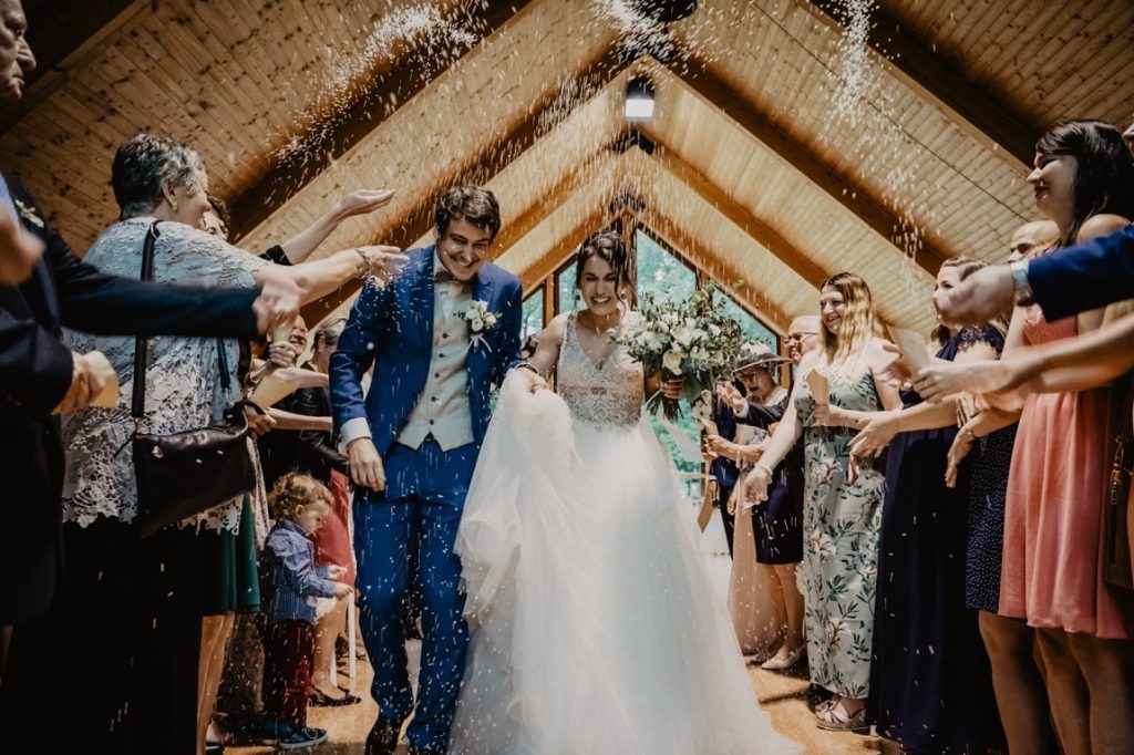 guests throwing confetti at newlyweds