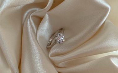 silver diamond ring on silk fabric
