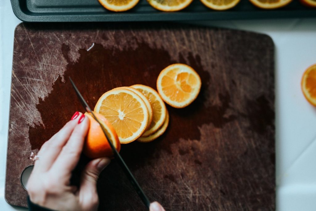 woman cutting out oranges