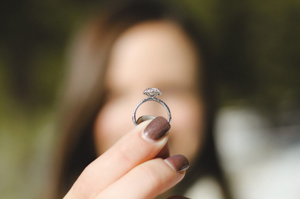 woman holding engagement ring