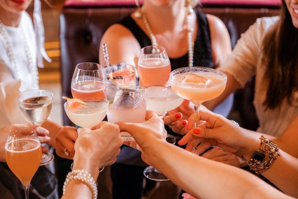 women clinking their cocktails