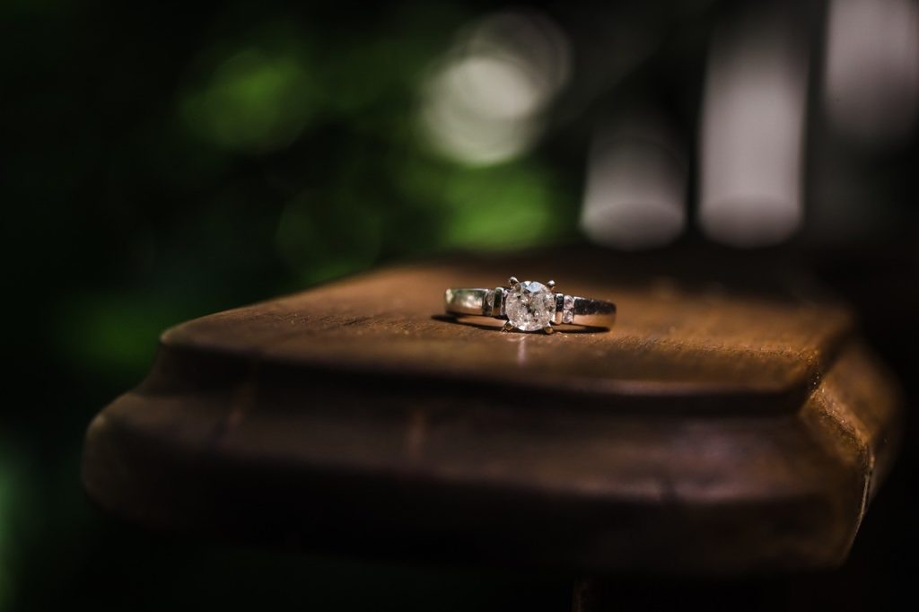 engagement ring on a wooden platform