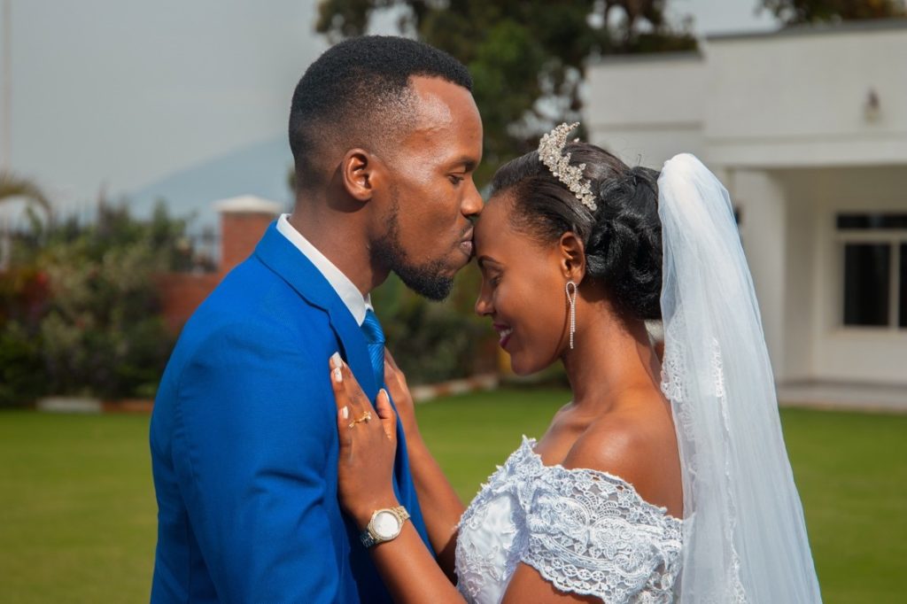 groom kissing bride's forehead