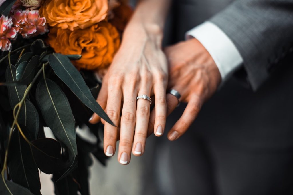 newlyweds showing off their rings