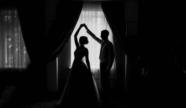 silhoutte of bride and groom dancing by the window