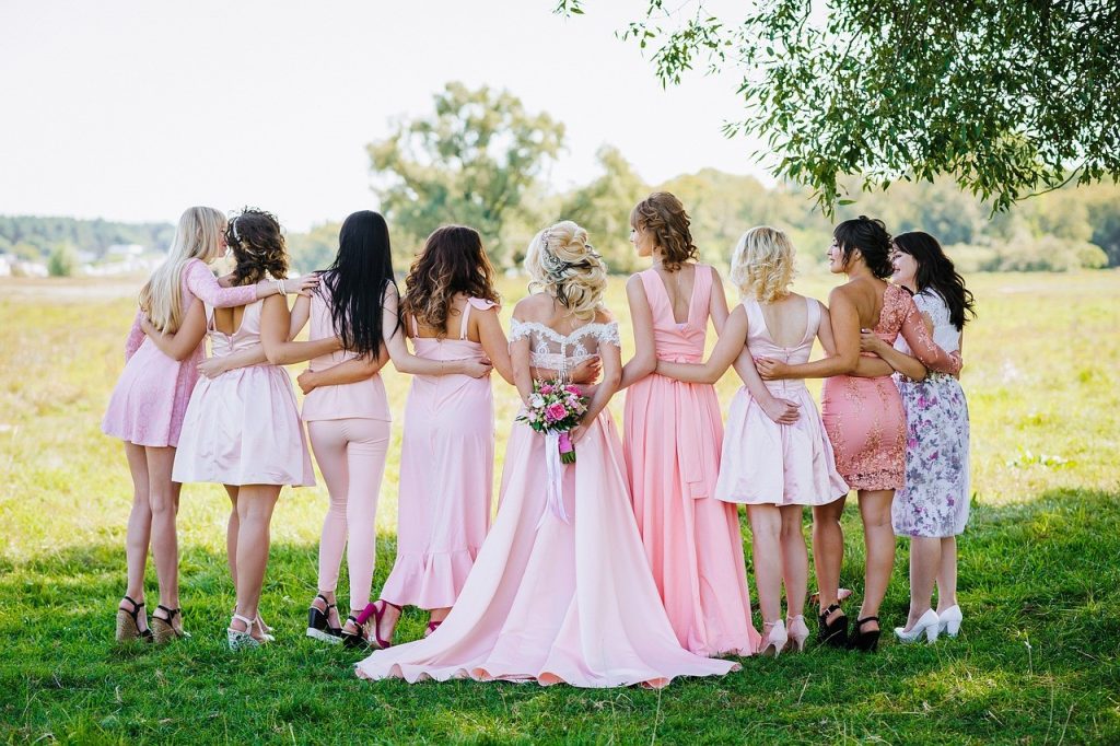 bride and bridesmaid hugging each other