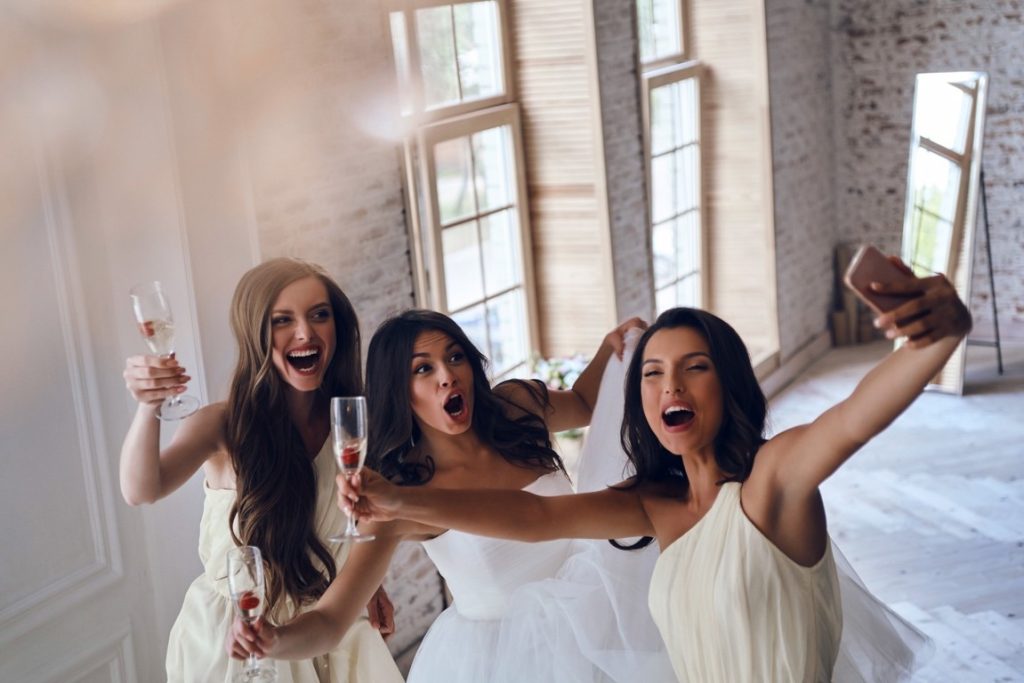 bride and bridesmaids taking a selfie