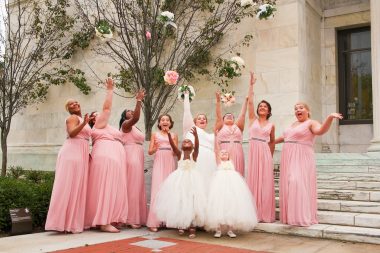 bride and bridesmaids throwing bouquet