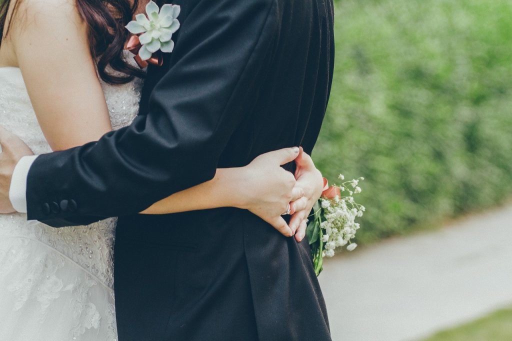 bride and groom hugging