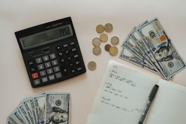 calculator, money, and notebook
