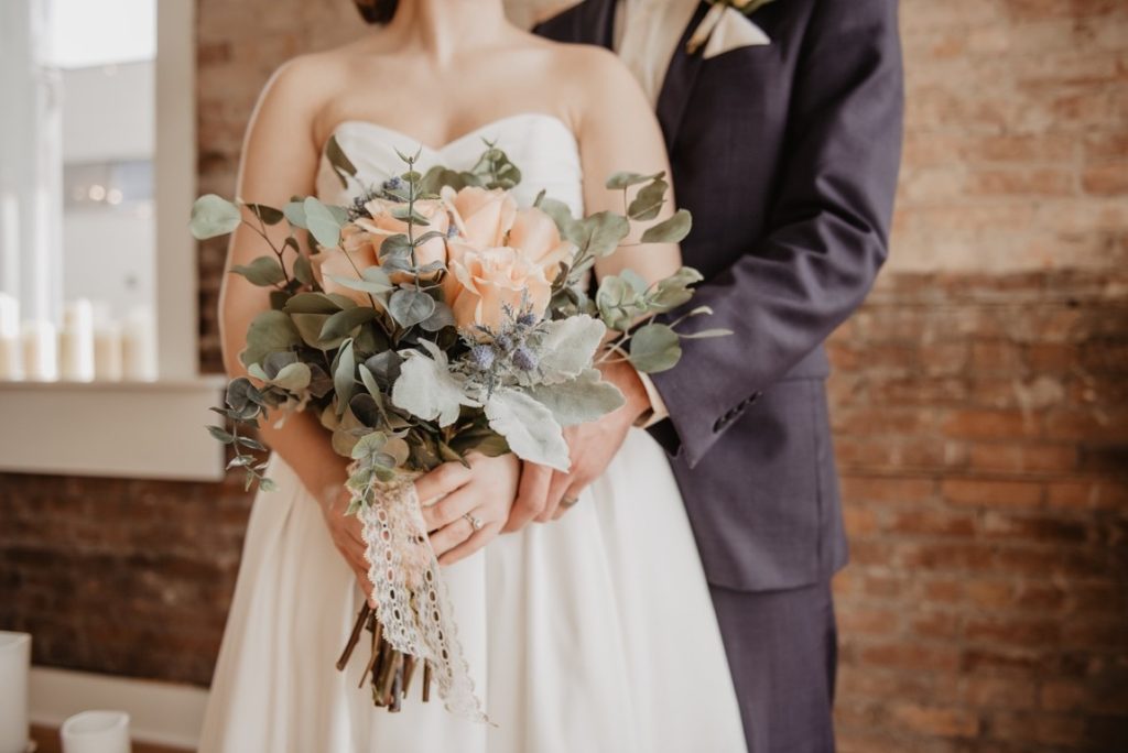 groom and bride holding a bouquet