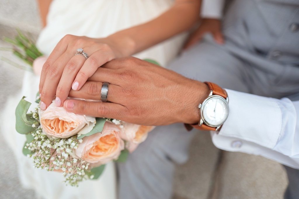 newlyweds hands on top of each other
