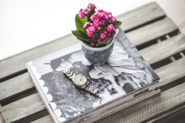 watch, magazines, and flower vase