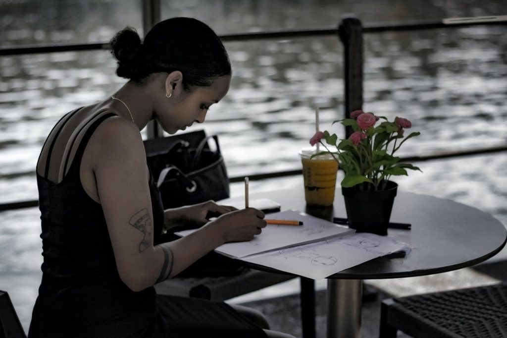 woman writing on a notebook