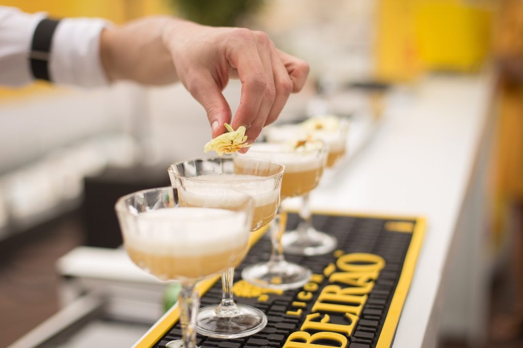 bartender putting pineapple on cocktail