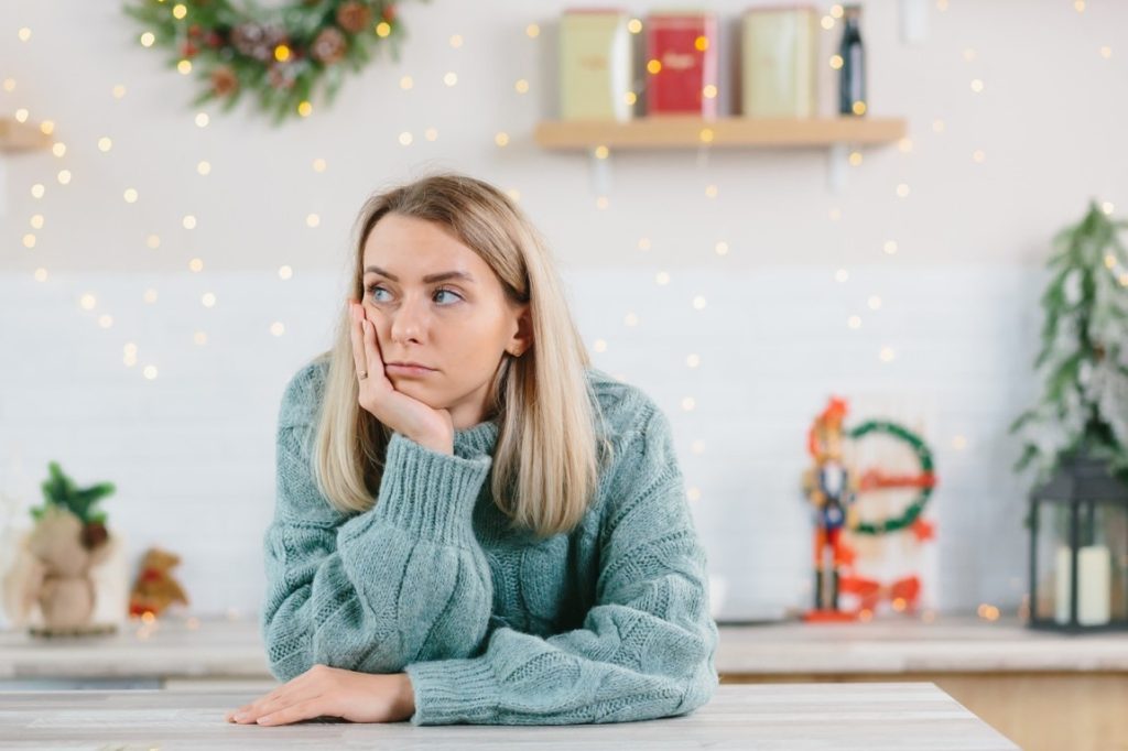 bored woman in green sweater