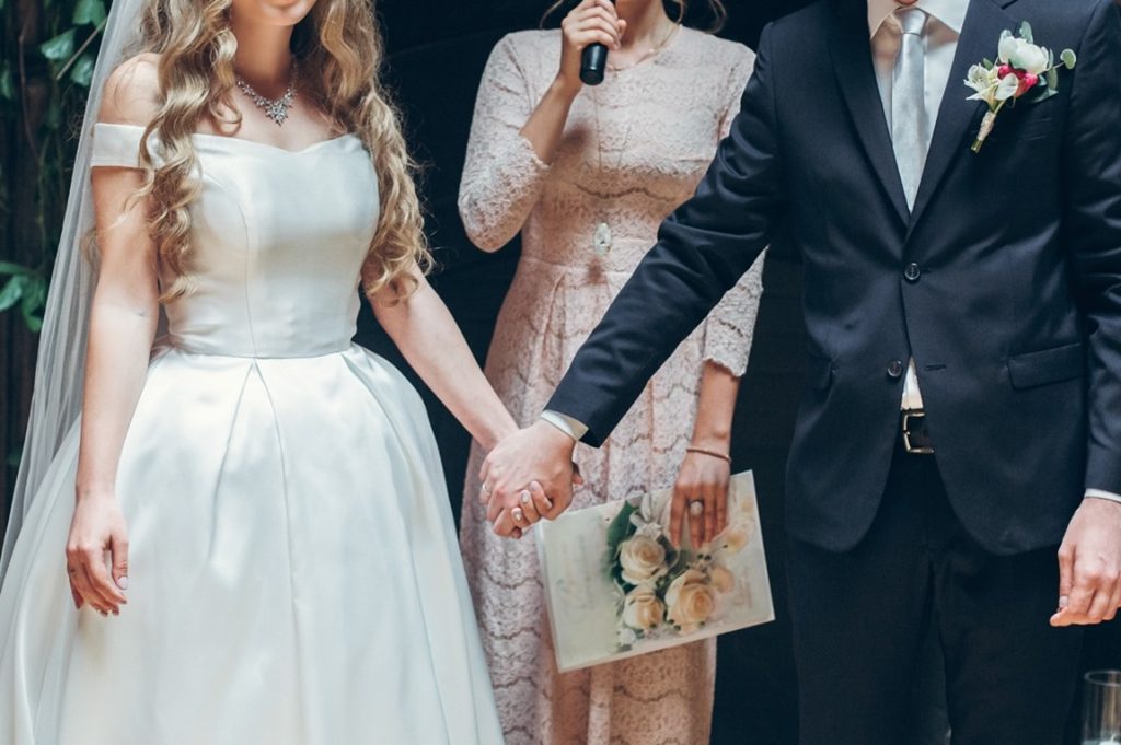 bride and groom holding hands