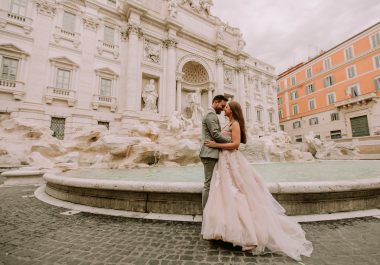 bride and groom in front of trevi fountain