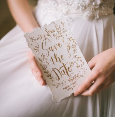 bride holding save the date card