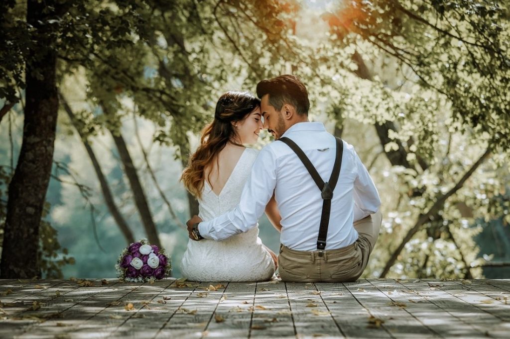 couple sitting on a wooden dock