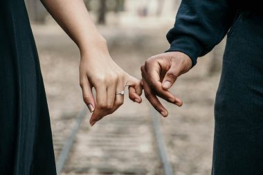 couple touching pinky fingers