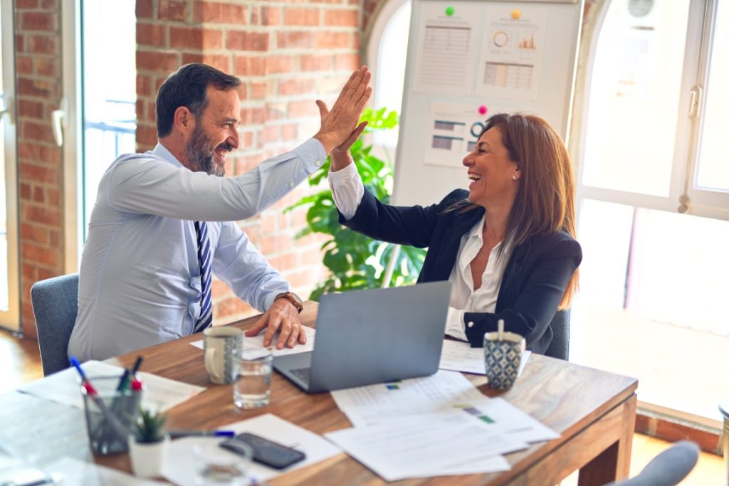 man and woman high fiving each other