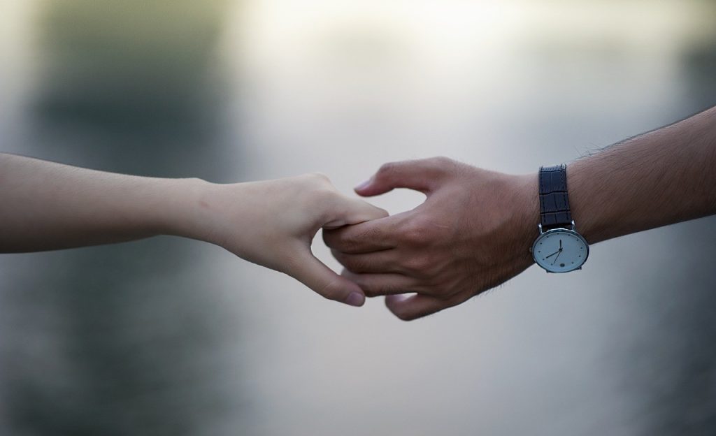 man and woman holding each other's hand