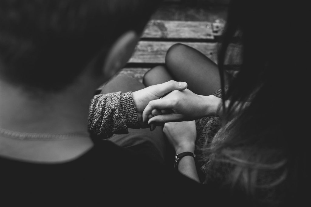 man holding woman's hand