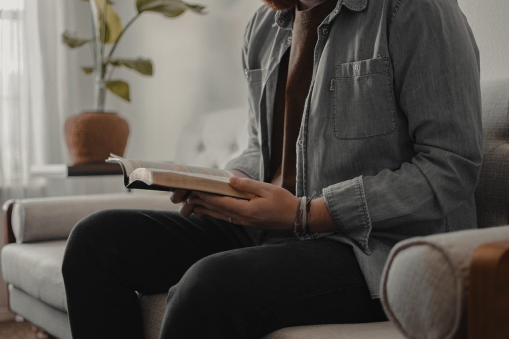 man reading on a couch